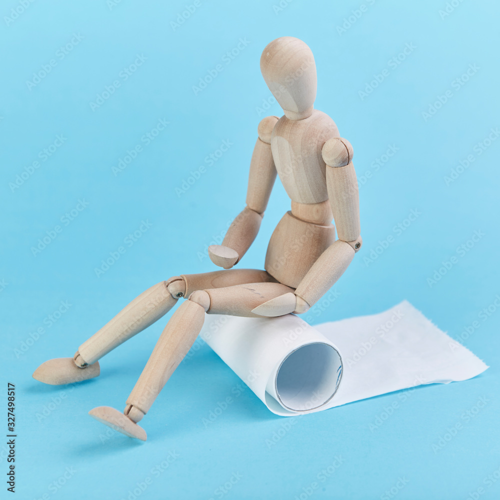 Puppet figures sitting on toilet paper with their stomachs covered Puppet figures sitting on toilet paper with their stomachs covered