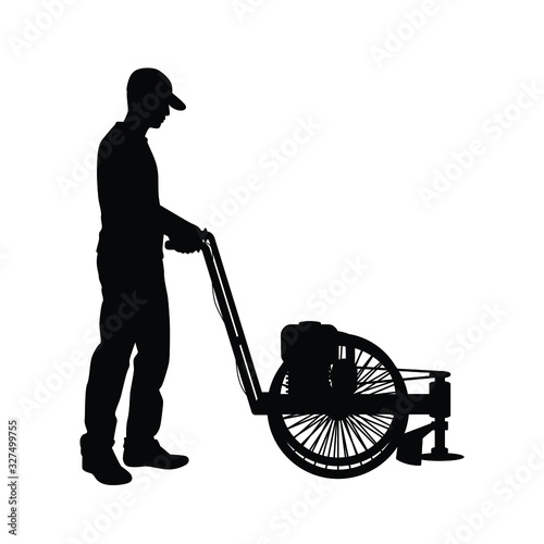 Man and grass mowing equipment silhouette