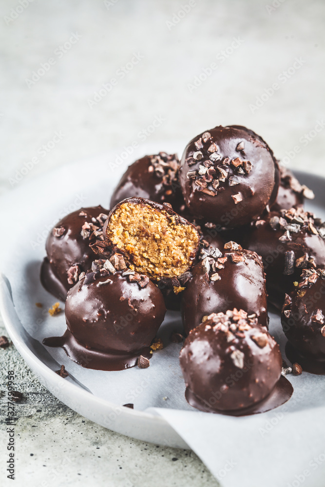 Vegan Chocolate Truffle Balls with peanut butter on gray plate.