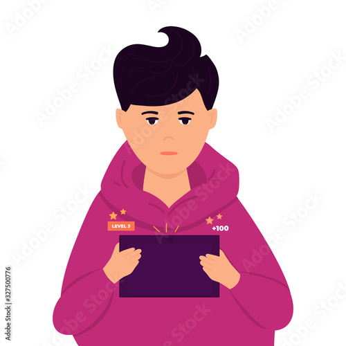 A boy plays a computer game on a tablet. A teenager uses a gadget. Digital addiction