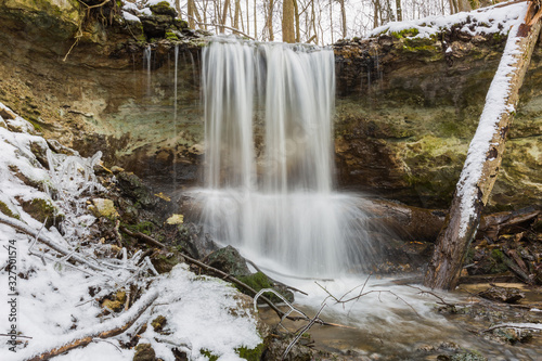 City Sigulda  Latvia. Waterfall in winter. White snow and trees. Travel photo.