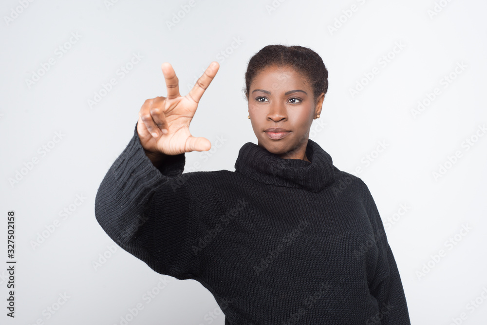 Front view of calm woman using virtual screen. Attractive young lady pressing something on imaginary screen. Virtual screen concept Front view of calm woman using virtual screen. Attractive young lady pressing something on imaginary screen. Virtual screen concept