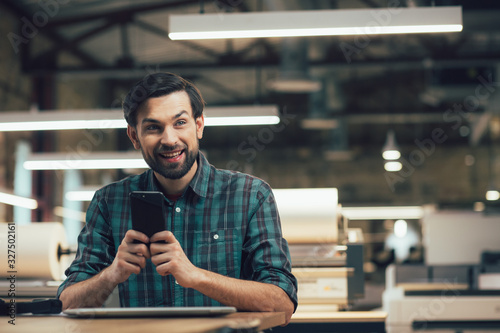 Happy smartphone owner looking away and smiling stock photo