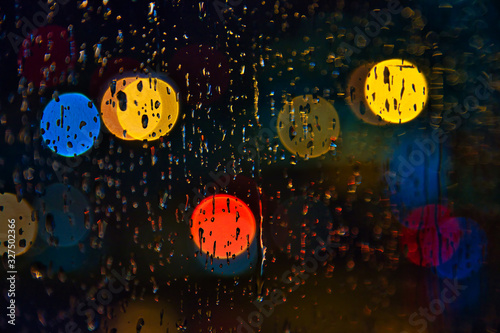 rainy days,rain drops on the window with traffic bokeh   