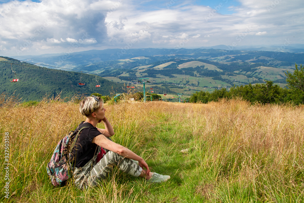 woman traveler resting in the mountains woman traveler resting in the mountains