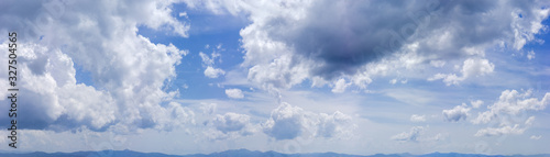 Panorama of the sky with clouds over the mountains