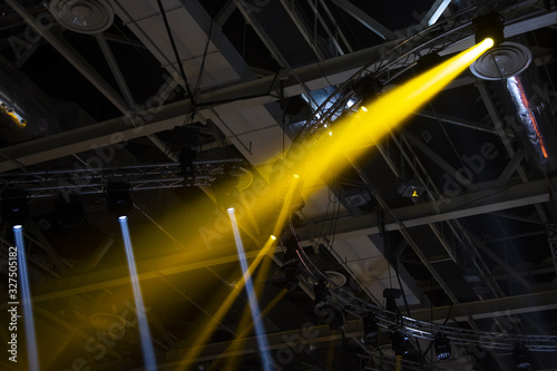 Spotlights. The stage for the performance is illuminated by floodlights. A ray of light breaks through the smoke.Lighting equipment for concerts and sports grounds.
