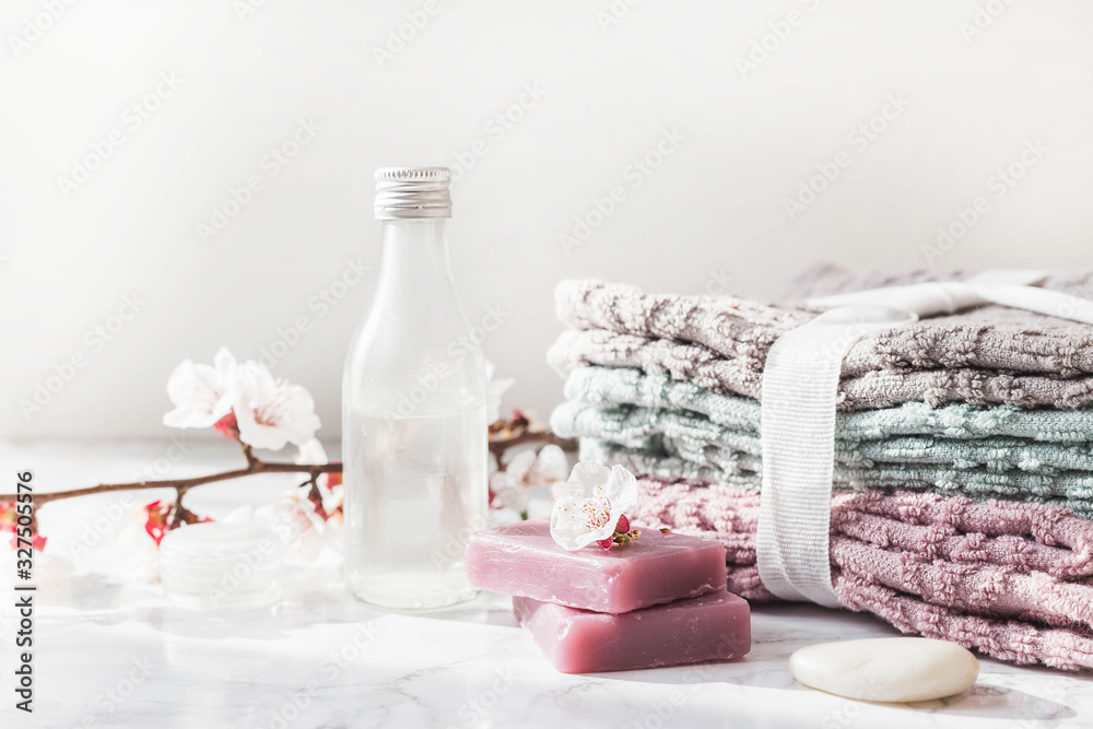 natural soap. handmade soap with a bottle of oil. Stack of fresh towels with flowers on a white background. spa treatments. natural soap. handmade soap with a bottle of oil. Stack of fresh towels with flowers on a white background. spa treatments.