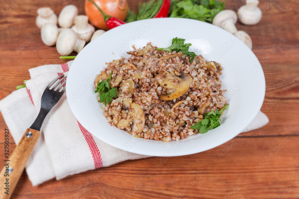 Buckwheat porridge with fried mushrooms and ingredients close-up Buckwheat porridge with fried mushrooms and ingredients close-up