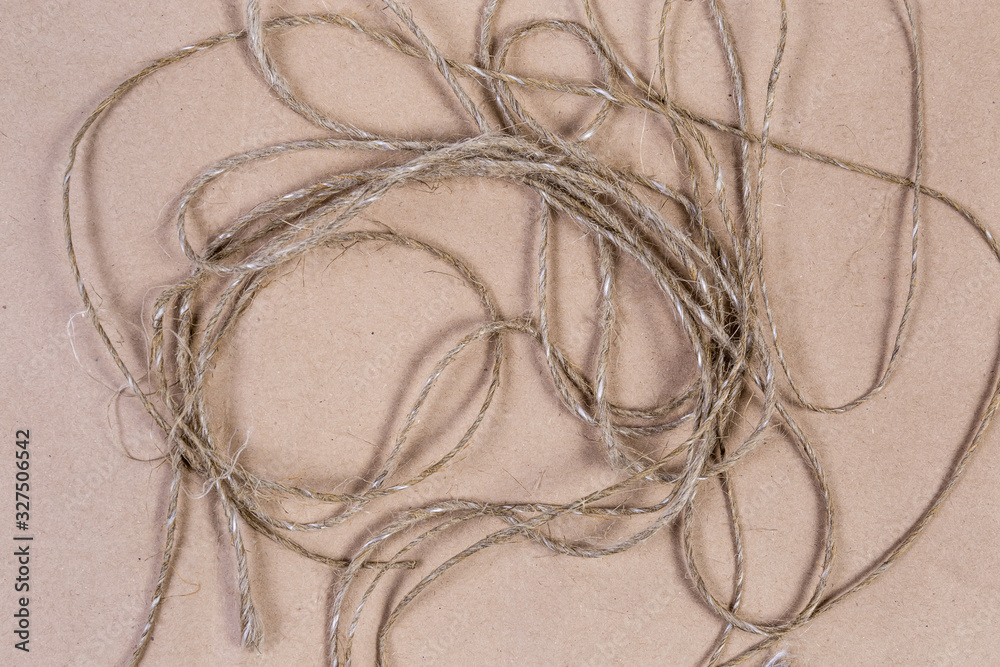 Background of unwound twine on a cardboard surface, fragment, texture Background of unwound twine on a cardboard surface, fragment, texture