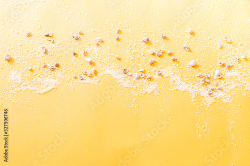 summer background. Summer traveling to the sea with shells and sea salt on yellow background top view mock up. copy space