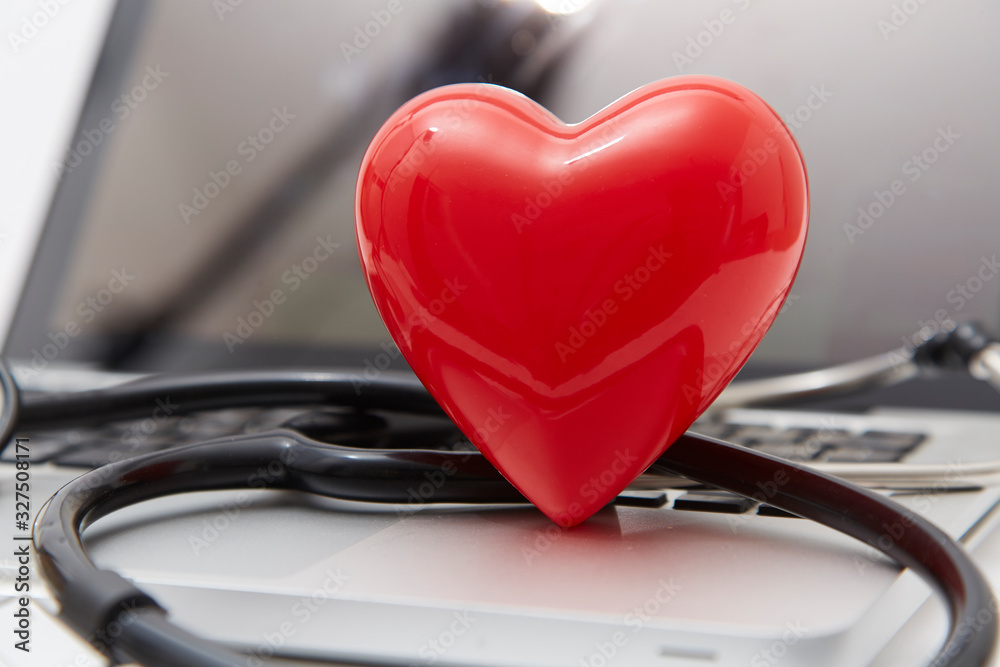 Red heart and stethoscope on laptop Red heart and stethoscope on laptop