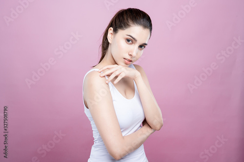 Mix asian caucasian woman confident beauty poses for healthy skin beauty in pink seamless background. Cosmetic, skincare, surgery concept. Her skin and face are beautiful, fresh and youthful.