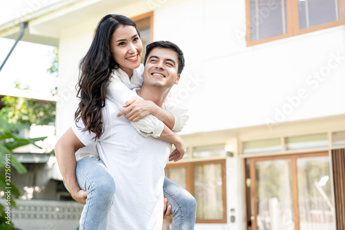 Couples of different nationalities to help buy homes for their families. The woman Ride on the man's back.Real estate, Family, Home loan saving, personal financial planning concept.