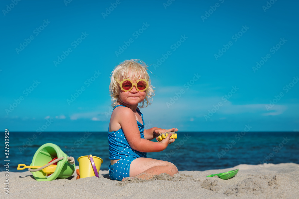 cute little girl play with sand on beach cute little girl play with sand on beach