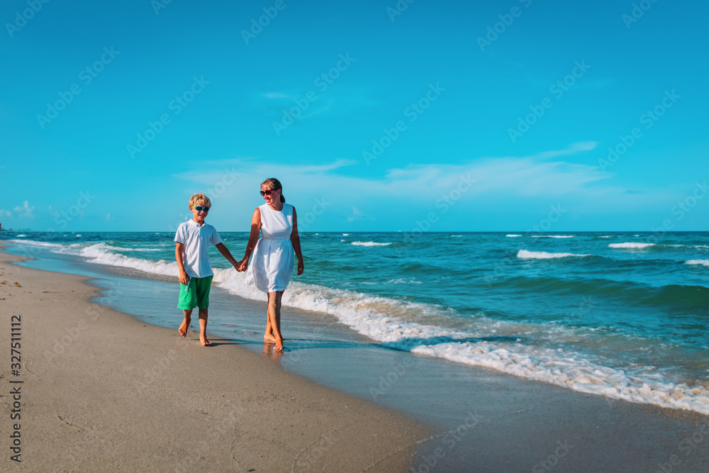 happy mother with son walk on beach, family at sea happy mother with son walk on beach, family at sea