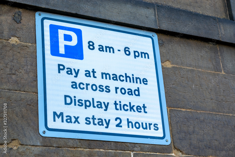 Pay and Display sign denoting to pay at the machine across the road and maximum stay of two hours. Pay and Display sign denoting to pay at the machine across the road and maximum stay of two hours.