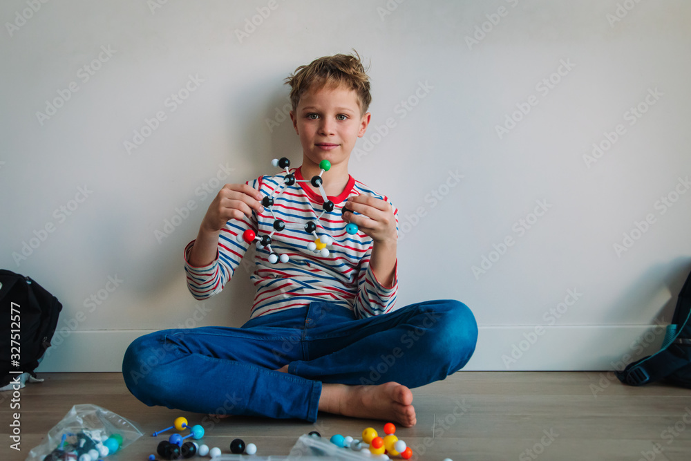 kid learning chemistry, making model of a molecule, STEM