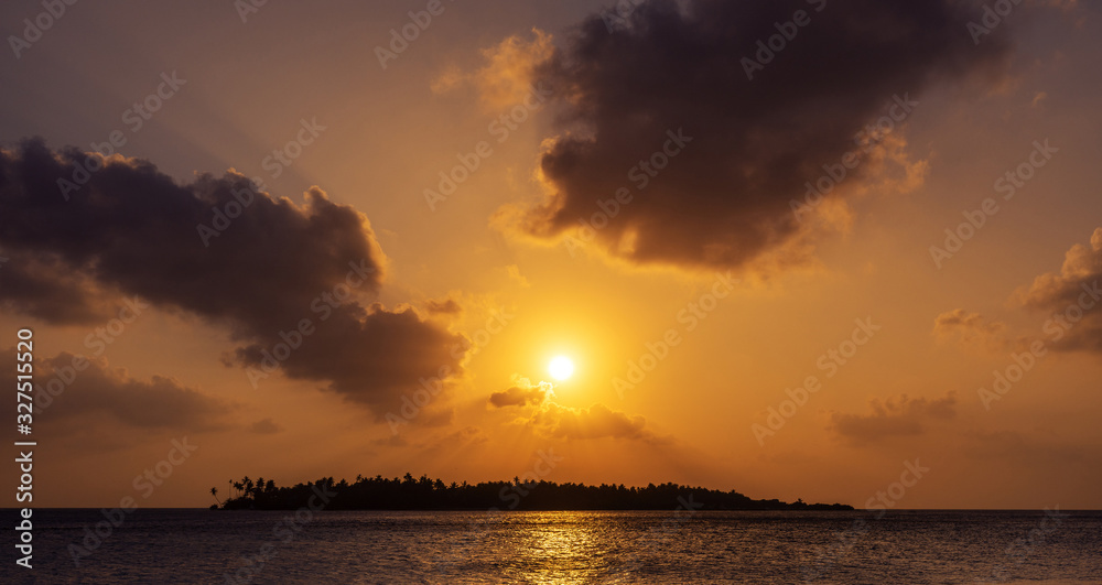 Naklejka premium dramatic sunset sky above a tropical island in Maldives