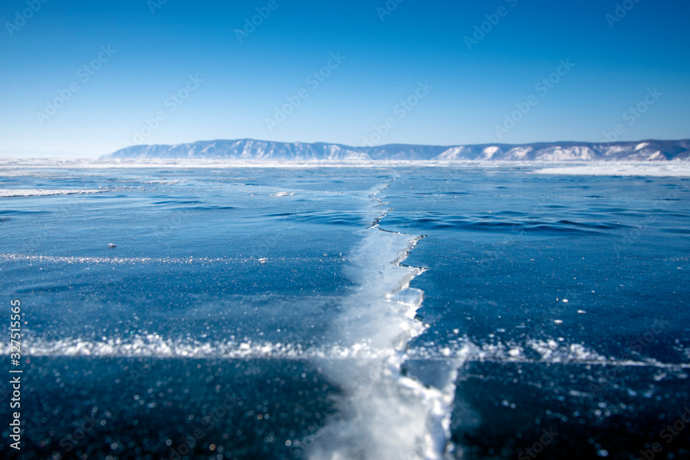 Methane Bubbles in the Baikal Ice.ice and cracks on the surface of Lake Baikal, Winter.Top view. Winter texture.Air bubbles in ice.Baikal ice. Crystal clear drinking water. 