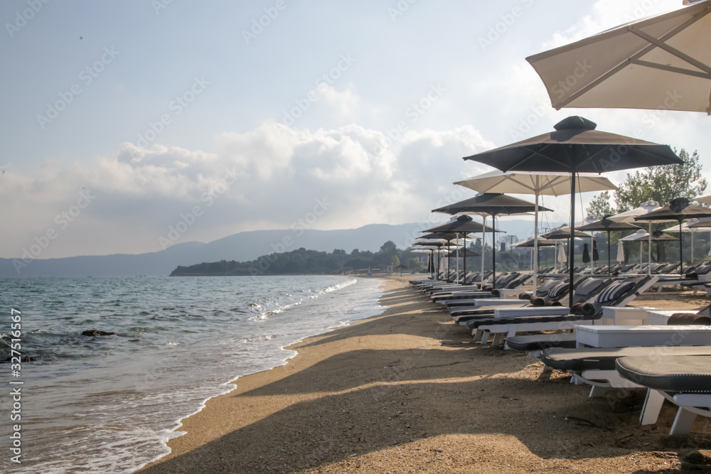 Luxurious sunbeds and umbrellas on a sandy beach