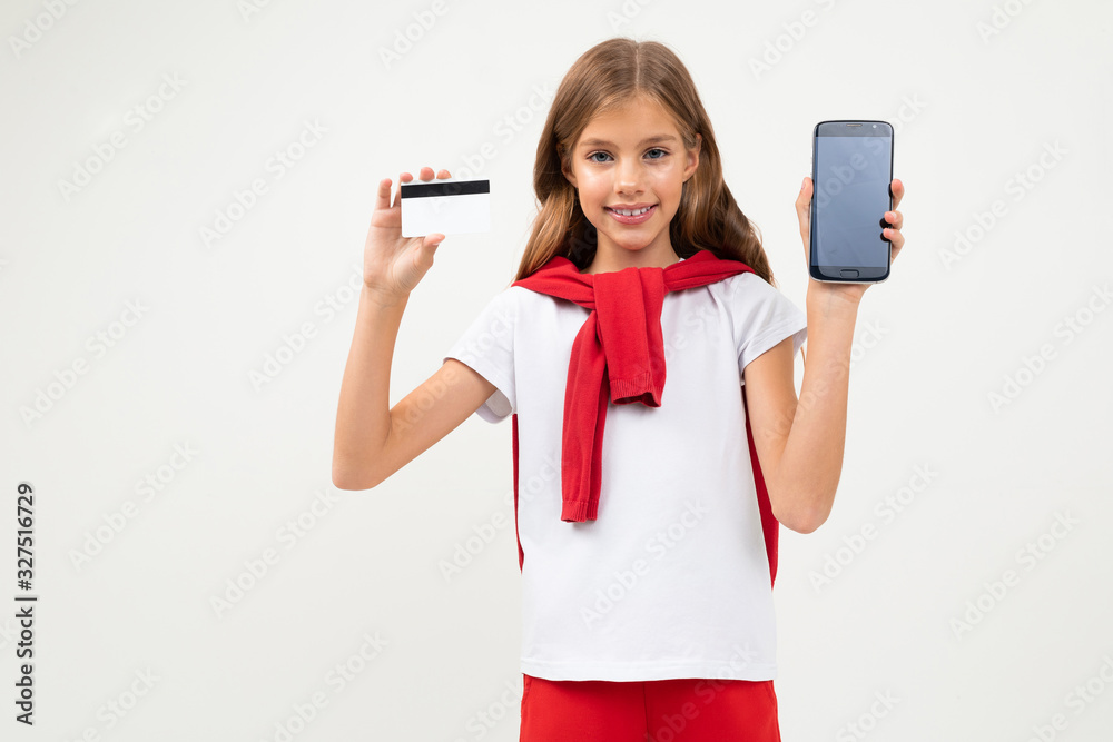 Cute teenager with beautiful face holds a credit card, picture isolated on white background Cute teenager with beautiful face holds a credit card, picture isolated on white background