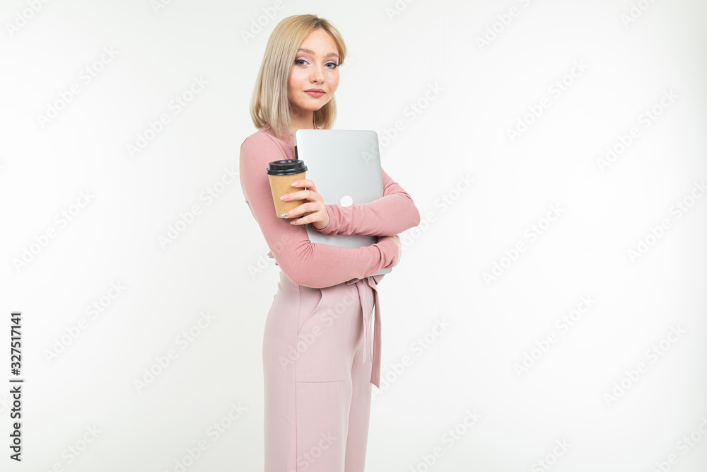 girl on a coffee break with a cup of coffee and a laptop in her hands on a white background with copy space