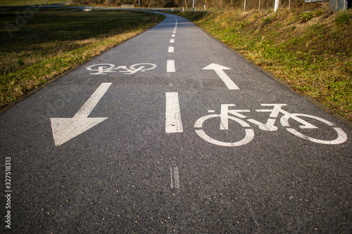 Bicycle path, two way cycling track with bicycle signs painted white