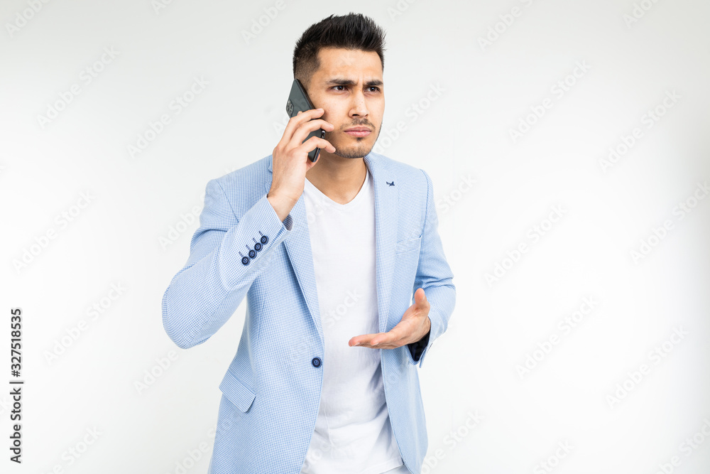 businessman in a jacket discusses important matters on the phone on a white background businessman in a jacket discusses important matters on the phone on a white background