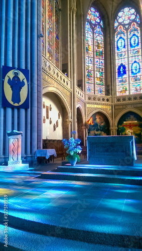 magnificent interior, bluish reflections of the stained glass windows of the Basilica of Notre-Dame de Pontmain, France. © Franck