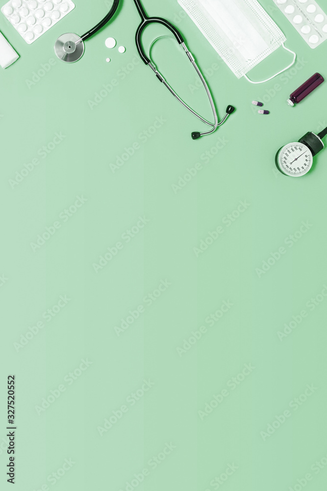 Medical mint green background with different accessories: stethoscope,  thermometer, syringe and tablets. Stock Photo | Adobe Stock