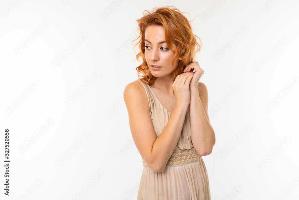 Cheerful woman with fair red hair in beautiful dress smiles, picture isolated on white background Cheerful woman with fair red hair in beautiful dress smiles, picture isolated on white background