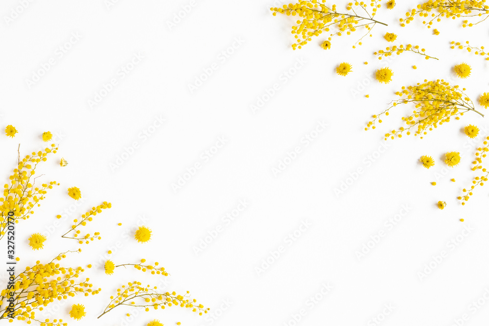 Flowers composition. Frame made of yellow flowers on white background. Spring concept. Flat lay, top view Flowers composition. Frame made of yellow flowers on white background. Spring concept. Flat lay, top view