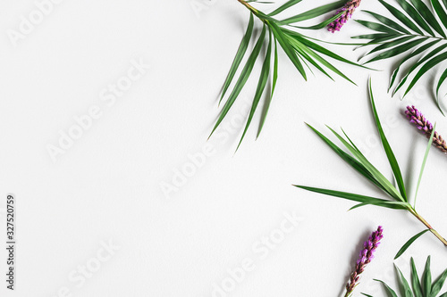 Fototapeta Naklejka Na Ścianę i Meble -  Summer composition. Tropical flowers and leaves on gray background. Summer concept. Flat lay, top view, copy space
