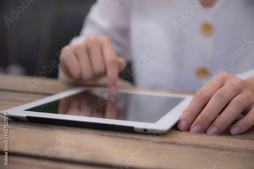 Women using tablet at wooden table