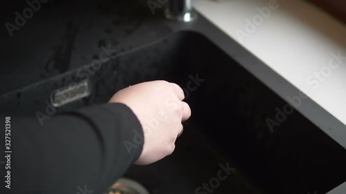 Woman washing hands under flowing water from tap in slow motion 180fps photo