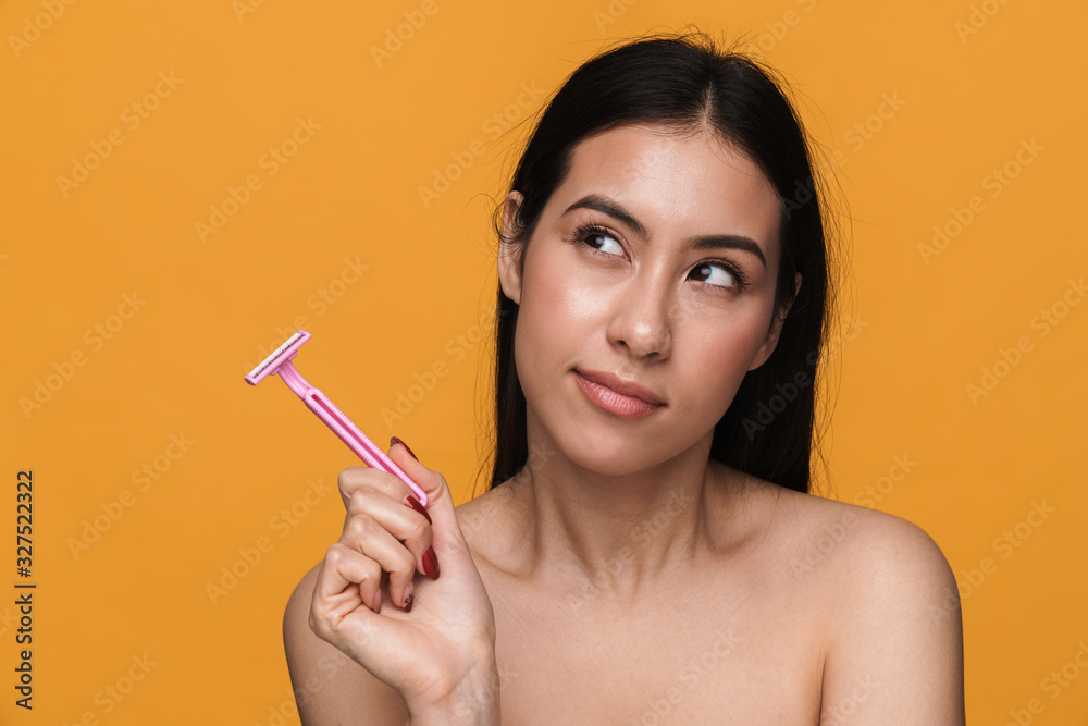 Beauty portrait of young half-naked woman smiling and holding razor Beauty portrait of young half-naked woman smiling and holding razor