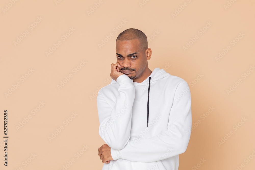 Pensive African guy with a white sweatshirt Pensive African guy with a white sweatshirt