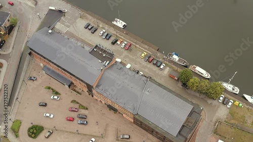 LIEPAJA, LATVIA - JULY, 2019: Aerial drone view of the Promenad hotel building near river canal by Baltic sea in Liepaja. photo