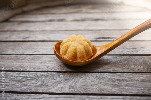 Kuih Bahulu or Baulu served in a wooden spoon.  Kuih Bahulu is a must have food during festive season such Hari Raya Aidilfitri photo