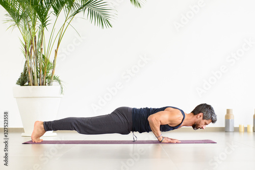 Fit man doing Yoga chaturanga push-ups