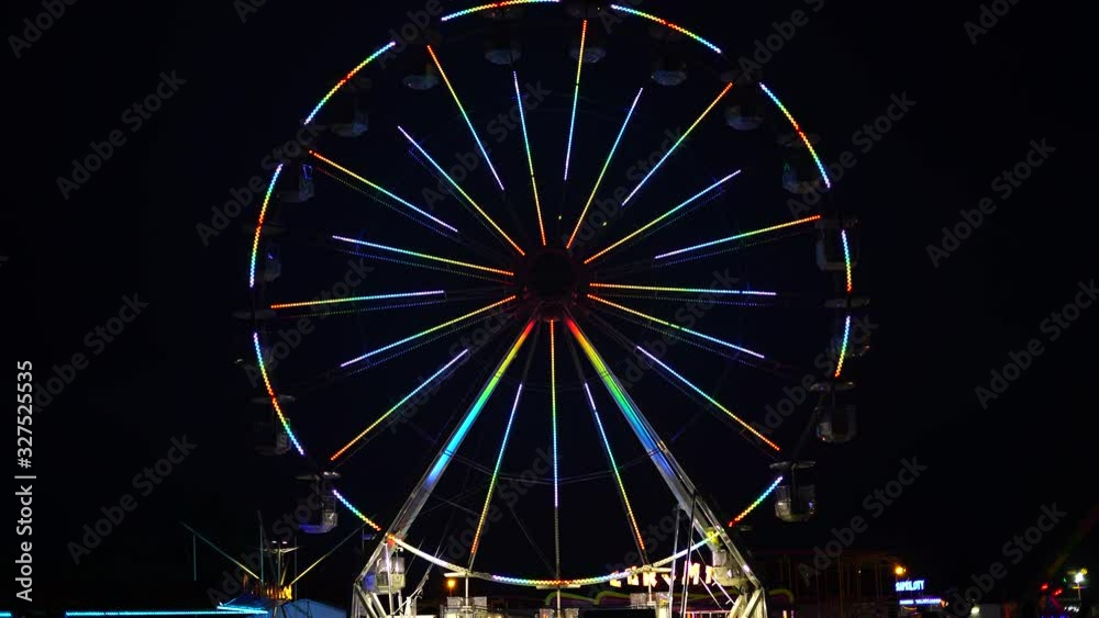 View of amusement park at night. Colorful ferris wheel in luna park View of amusement park at night. Colorful ferris wheel in luna park