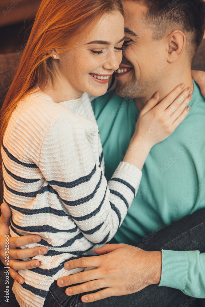 Red haired caucasian girl with freckles is held by her lover during a warm morning together Red haired caucasian girl with freckles is held by her lover during a warm morning together