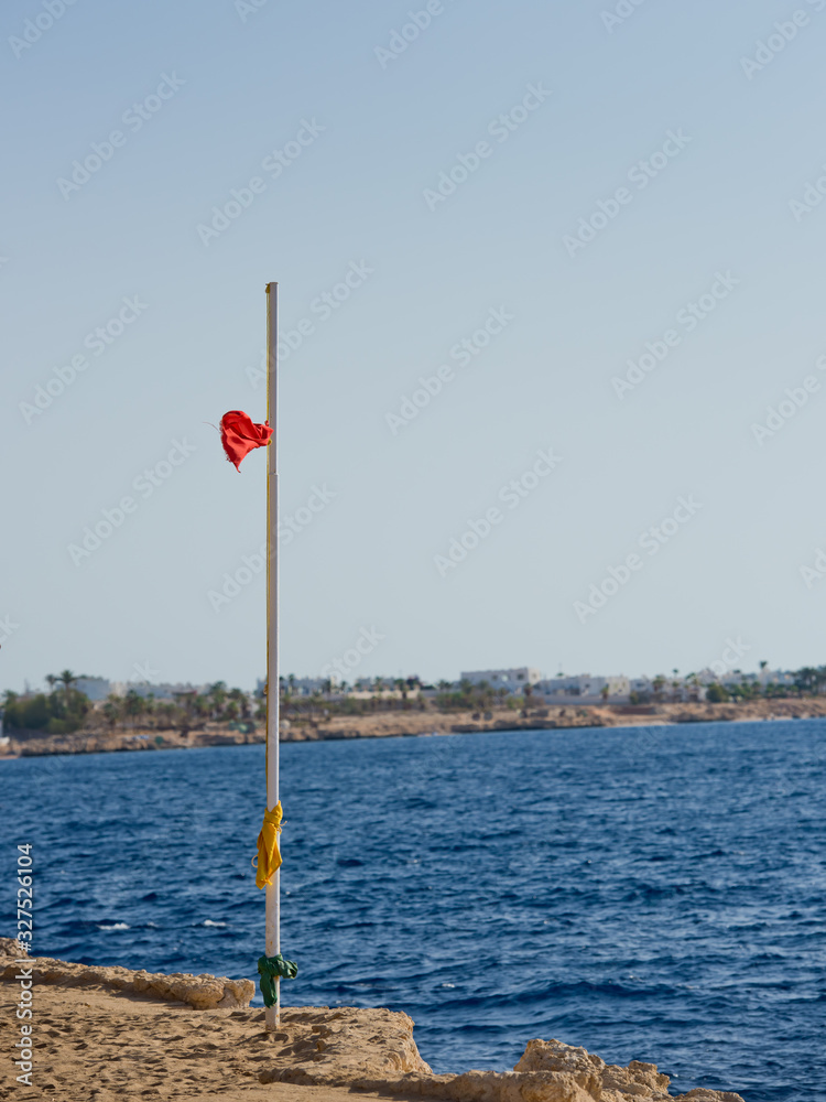 Fototapeta premium Red flag with the sea, Signal warning. Storm warning.