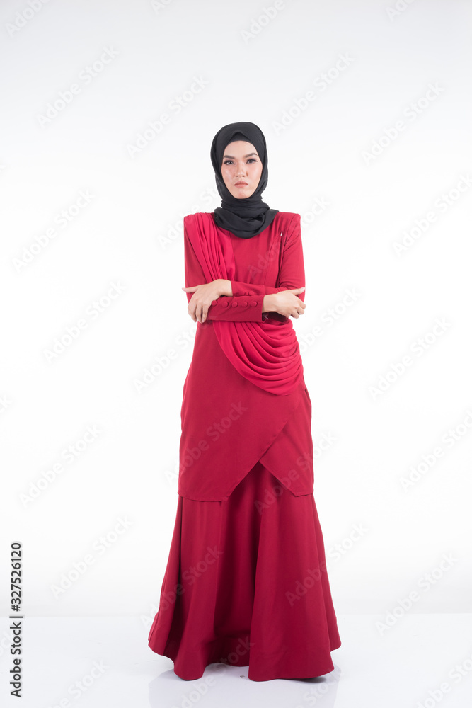 Beautiful female Asian model in various poses wearing a red Malaysian traditional wear isolated on white background. Beauty and fashion concept. Full length portrait Beautiful female Asian model in various poses wearing a red Malaysian traditional wear isolated on white background. Beauty and fashion concept. Full length portrait