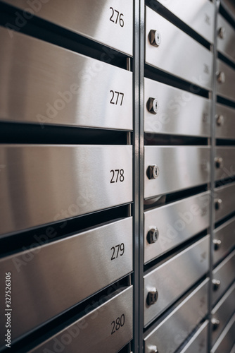shiny metal mailboxes in the entrance of the house