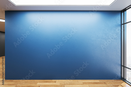 Empty spacious room with blank blue wall. photo