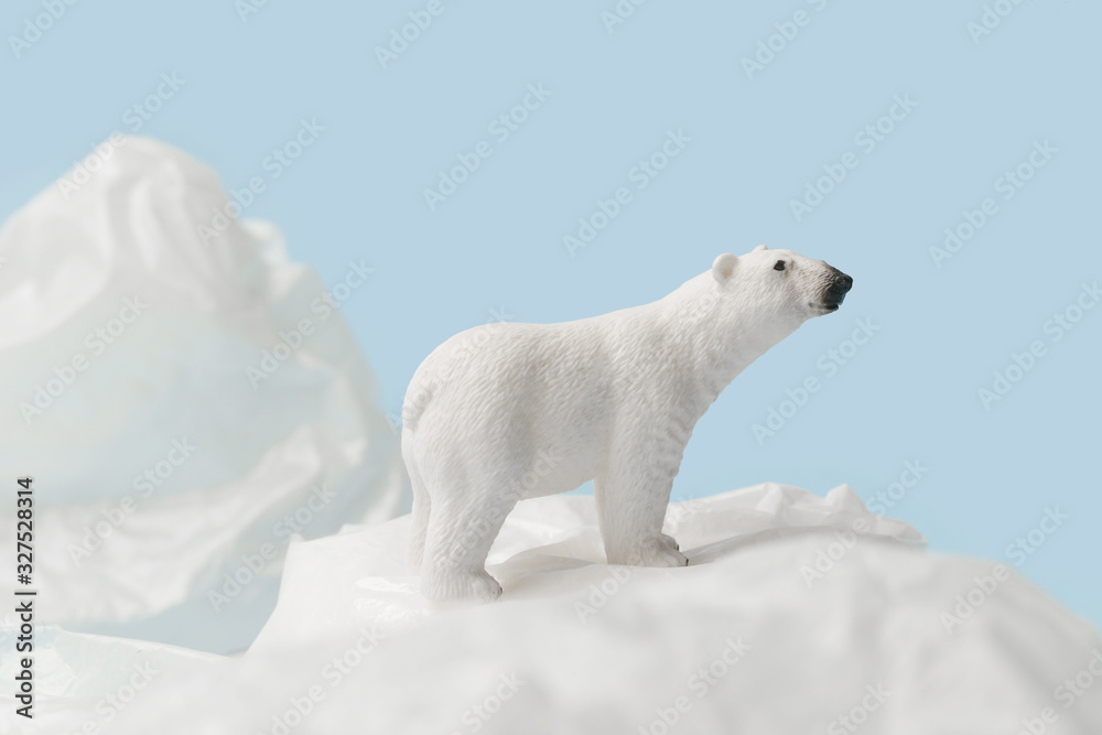 Naklejka White polar bear on plastic bag on blue background, plastic pollution and climate change concept