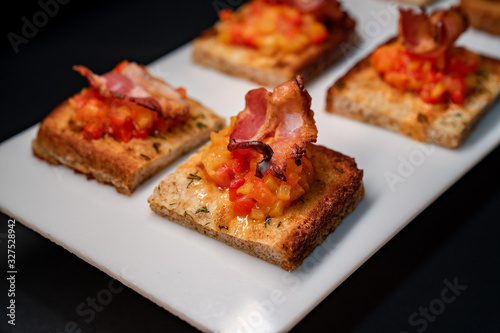 toast with vegetables and bacon, close up