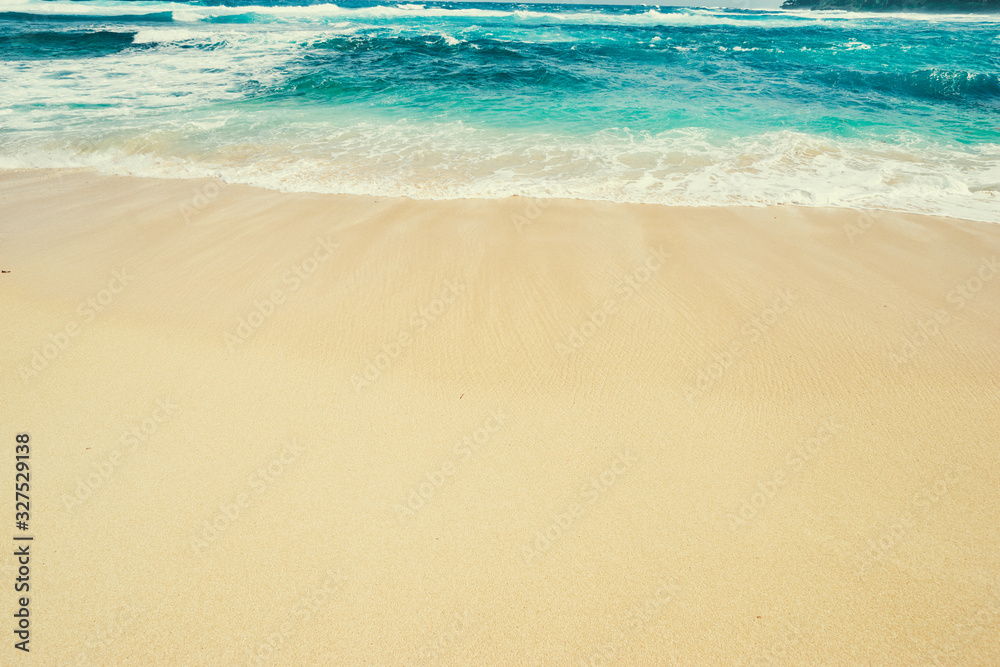 Textured background. Sand and water. Tropical beach.